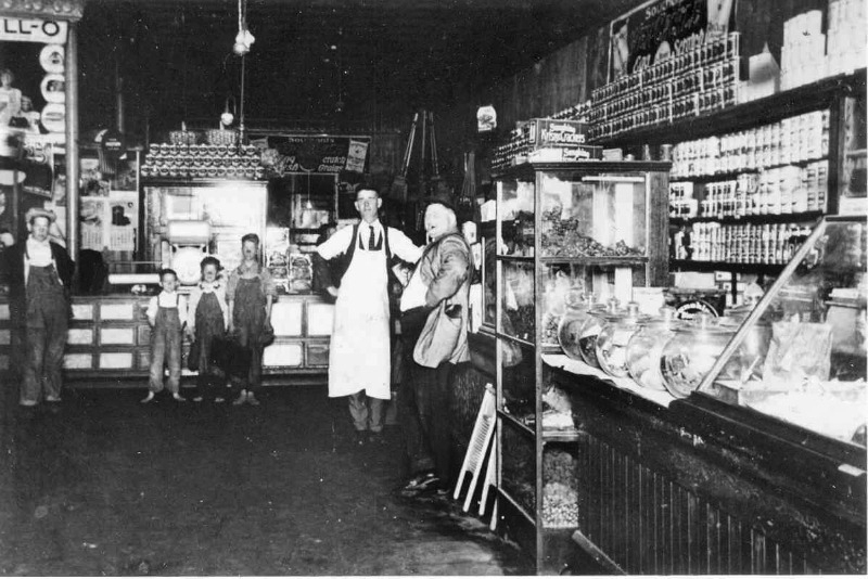 Photo of men and children inside an old general store